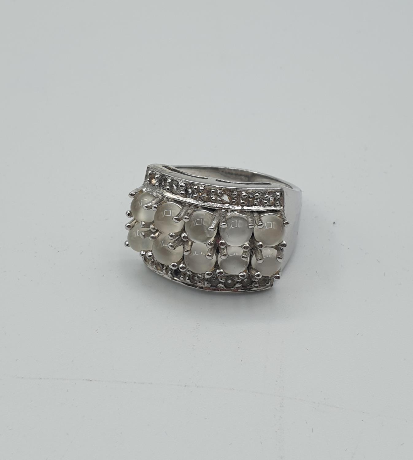 Stone set silver and moonstone ring having 10 stones bordered by two rows of clear stones. - Image 3 of 4