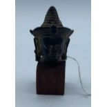 Small bronze Buddhist head on wooden stand from early 10th century, 7.5cm tall and weight 77g