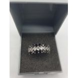 Stone Set Silver ring having two rows of gleaming jet black stones to the sides with clear stones to