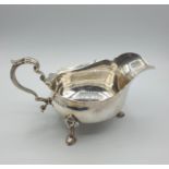 Antique Silver Sauce/ Gravy boat with three cabriole legs and having an unusual scale design to