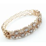 18ct rose gold bangle encrusted with baguettes and other diamonds in excess of 2ct