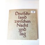 A 1934 edition of Deutchland Zwifchen Nacht Und Tag documenting the rise of the Nazy party, 26 x