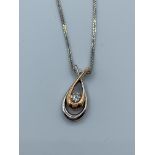 14ct white and rose gold pendant with central diamond on 42cm chain , weight 3.08g