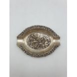 A hand embossed silver tray late 19th century. The weight is 39g.