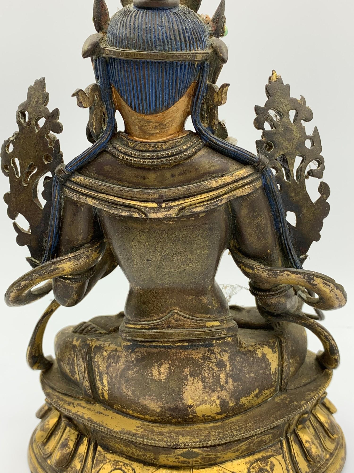 A very early Tibetan religious deity gilt on bronze with turquoise stones and painted dace, weight - Image 8 of 14