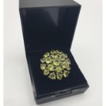 Vintage stone set silver and peridot ring having 19 stones set in flower formation. Size N