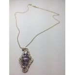 Silver and tanzanite pendant with silver gilt chain necklace, having 9 stones set in a lozenge