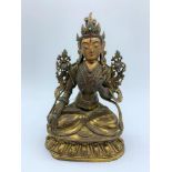 A very early Tibetan religious deity gilt on bronze with turquoise stones and painted dace, weight