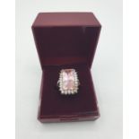 Stone Set Silver Ring with a large rectangular pink stone bordered by 24 zirconias. The silver