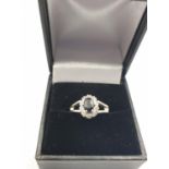 Sapphire and diamond ring set in 18ct white gold, classic design with an oval sapphire centre