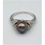 Platinum ring with black/silver pearl stone and 2 single diamond shoulders, weight 6g and size M