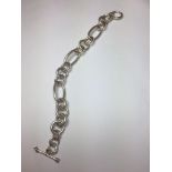 Silver bracelet with large oval and round links, having a T bar clasp and hallmark showing on the