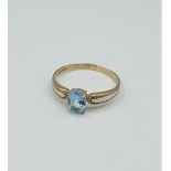 9ct yellow gold ring with aqua marine coloured oval stone, weight 1.4g and size O