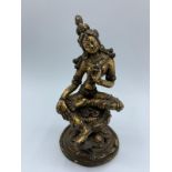 A hand carved Tibetan statue of Goddess in gilt covered bronze with turquoise shoulder stones, 12.