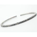 18ct white gold bangle with black and white diamonds, weight 11.3g