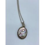 A silver pendant with necklace mother of pearl face, weight 2.7g and 44cm long