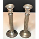 A pair of early silver column candlesticks, with a weight of 242g
