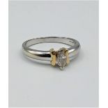 18ct white gold ring with oval diamond and yellow gold shoulders, weight 3.6g and size O