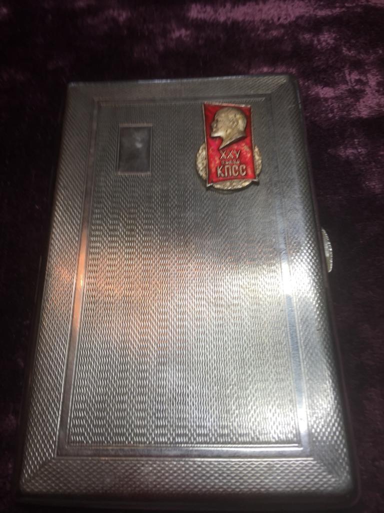 Vintage white metal Russian cigarette case, having a red badge of Lenin and a Russian inscription