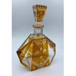 A large amber coloured cut glass decanter art deco style, 24cm high and 18cm wide