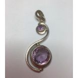 Silver and amethyst drop pendant, having two large amethyst in a silver scroll shaped setting, 5.5cm