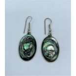 Pair of silver earrings with patterned enamel faces, weight 7g