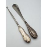 Antique silver shoe horn and buttoner. Handles are hallmarked silver. 24cm long each. Birmingham