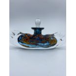 An unusual shaped perfume bottle with dipper.The height is 9.5cm and the width is 20cm.
