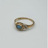 9ct yellow gold ring with unusual 'eye' shaped centre blue stone with diamonds shoulder, weight 1.6g