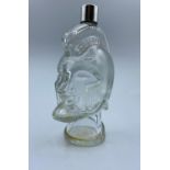 A large glass aftershave bottle in the shape of a spartan warrior's head. The height is 16cm.