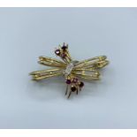 Ruby and diamond brooch set in 18ct yellow gold in a bow shape, weight 7g