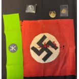 A small swastika flag on red background (poor condition) plus belt buckle, green arm band, day badge