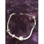 Amore and Baci silver bracelet with five charms plus the Amore & Baci silver tag, 21cm long and