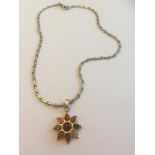 Scandinavian silver amber pendant and chain, the pendant in the form of a flower and having nine