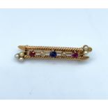 Antique bar brooch with rubies, diamonds and sapphire centre (old cut)set in 18ct gold, weight 4,.4g
