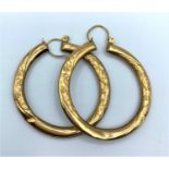 Pair of 9ct big hoop engraved earrings, weighs 3g.