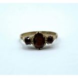 A vintage 9ct gold ring with garnet trilogy, weight 2.5g and size P