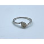 9ct white gold crossover ring with 0.25ct diamonds cluster, weight 1.3g and size L/M