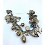 A silver charm bracelet with padlock catch. Having around 30 assorted charms. It weighs 91g and it's