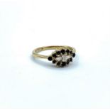 9ct yellow gold ring with 3 diamond centre baguettes surrounded by 12 sapphires, weight 2.1g and