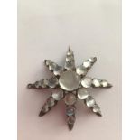 Stone set white metal brooch/pendant (tested as silver), having 25 moonstones in an eight pointed