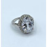 Silver stone set dress ring with large CZ stone centre, weight 7.8g and size U