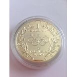 USA silver proof dollar minted in 1988 to celebrate the Olympic games, having its unopened