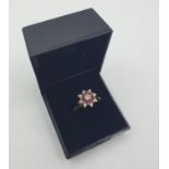 Stone set 18ct gold ring with diamonds and rubies. Mounted as an eight pointed star,with an inner