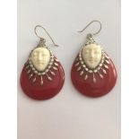 Unusual silver and red carnelian drop earrings, having cream faces and silver work to front