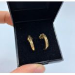 Pair of 9ct yellow gold earrings with 0.3ct diamond inset, weight 1.6g
