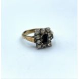 Goldsil ring with black stone centre and surrounded by small CZ stones, weight 3.5g and size Q