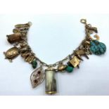9ct yellow gold charm bracelet with over 20 charms, weight 38g approx