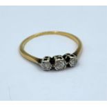 A vintage fine yellow metal ring with diamond trilogy, weight 1.8g and size R