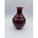 Chinese Sang de boeuf glaze. Rippled vase signed to base, 16cm x 10cm